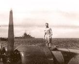 Lt. George J. Grimm stands on the wing of his PB2Y Coronado in Tokyo Bay.