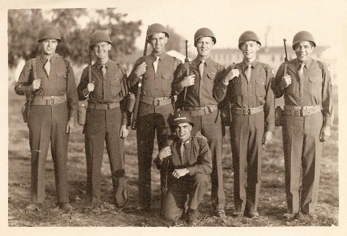 Picture of the signals team taken at Camp Crowder, Missouri, in 1944 before shipping out to India. Standing left to right: Edward Dalton, Marshall Windmiller (age 20), Joseph Ecaltz, Virgil Danielson, Irwin Miner, Guiseppe Macaluso. Kneeling: William Rodemann (Lt.)